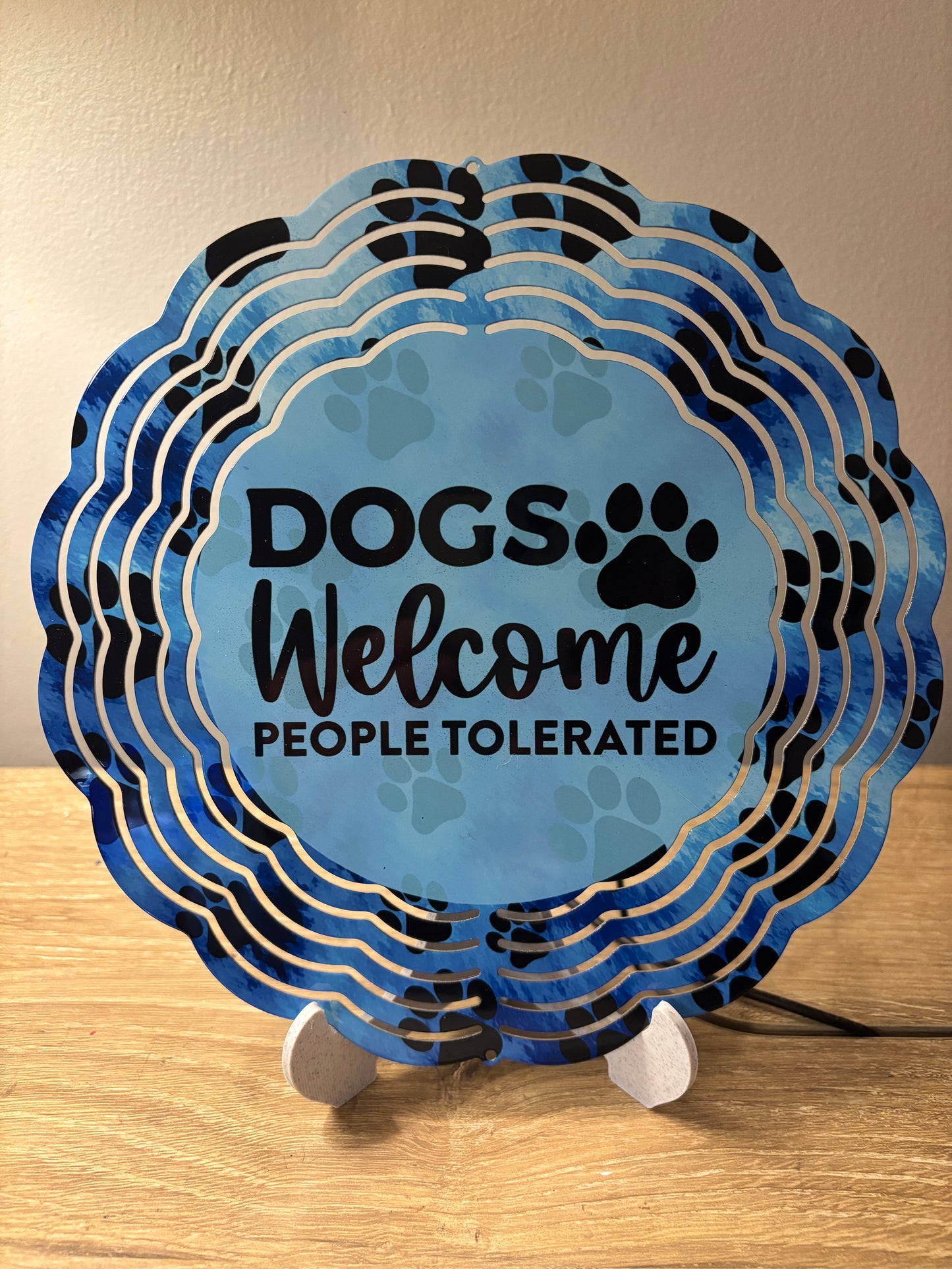 “Dogs Welcome, People Tolerated” Paw Print Wind Spinner – 8"